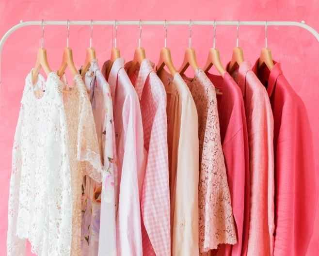 Clothing rack with pastel and pink outfits Clothing rack with pastel and pink outfits